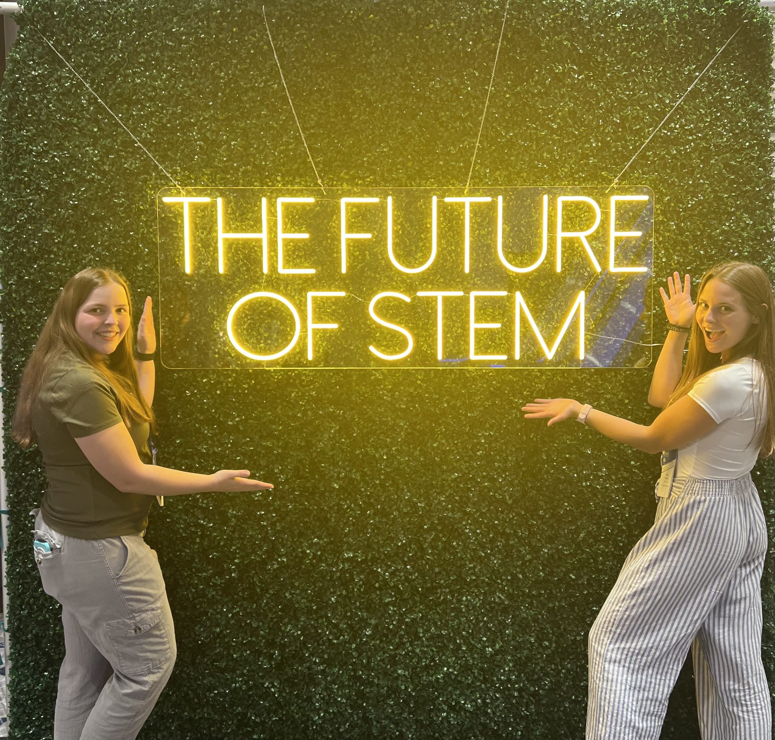 Two students standing under a The Future of Stem sign