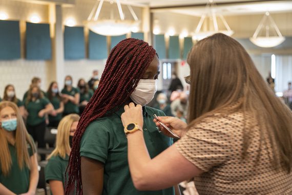 A sophomore nursing student, being inducted into the BSU nursing program