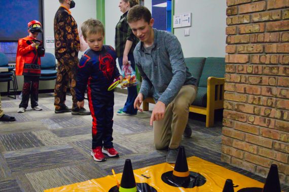 A BSU student plays a game with a child during Halloween festivities at BSU