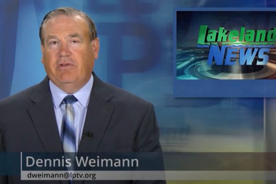 A screenshot of a newscast. A man in a dark suit and blue shirt in front of a Lakeland News logo.