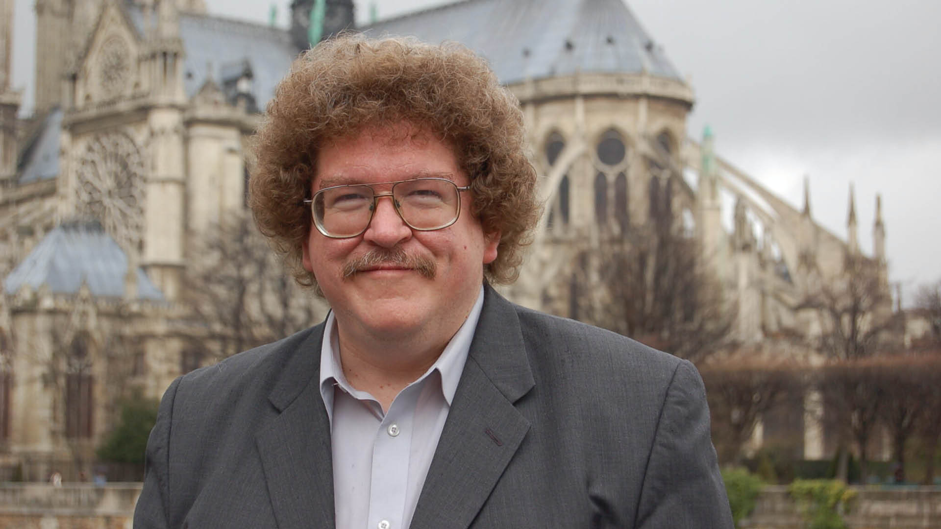 Eric Ewazen is standing in front of Notre Dame Cathedral in France