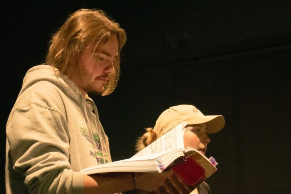 Carson Binkley reviews his score during rehearsal.