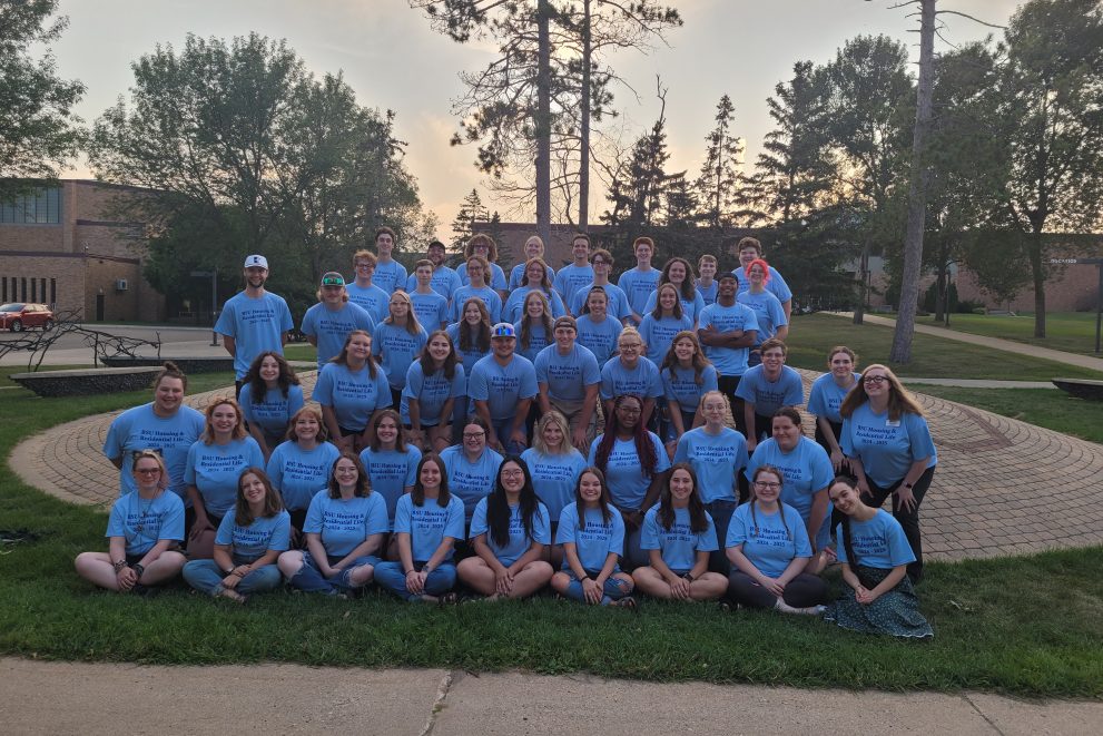 Group of student RAs, PAAs, ARHDs, and ABM along with the Area Directors outside of Tamarack Hall.