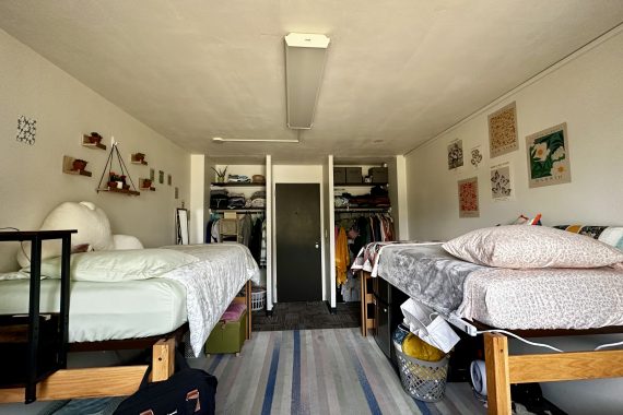 Oak double room with two unlofted beds view of the closets and hallway door